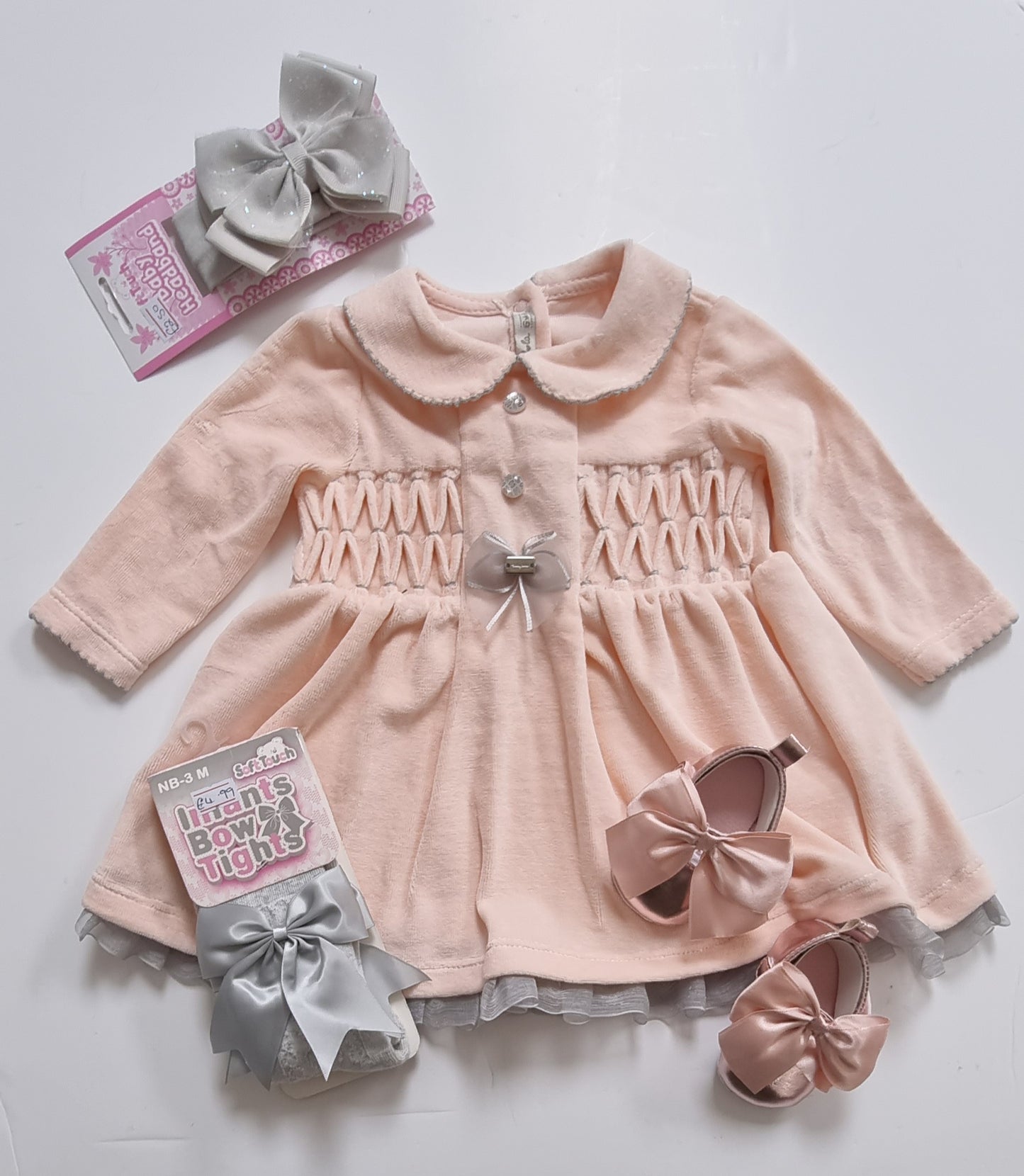 Velour baby dress in a peachy pink colour